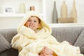 Happy smiling kid sitting in bathrobe at home sofa Royalty Free Stock Photo