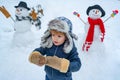 Happy smiling little boy child make snowman on sunny winter day. People in snow. Making snowman and winter fun for Royalty Free Stock Photo