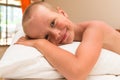 Happy smiling little boy lying on a pillow