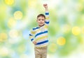 Happy smiling little boy with raised hand Royalty Free Stock Photo