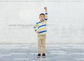 Happy smiling little boy with raised hand Royalty Free Stock Photo