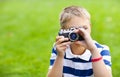 Happy smiling little boy with retro vintage camera Royalty Free Stock Photo