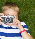 Happy smiling little boy with retro vintage camera Royalty Free Stock Photo