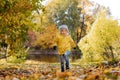 happy smiling little boy in yellow jacket run in autumn central park in Saint-petersburg, Russia on sunny october day Royalty Free Stock Photo