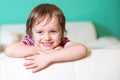Happy smiling little child boy sitting on a sofa Royalty Free Stock Photo