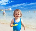 Happy smiling little child girl playing on a sea beach Royalty Free Stock Photo