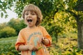 Happy smiling little child with green young pad peas in garden. Healthy eating, vegetables, legumes. Funny boy eating Royalty Free Stock Photo