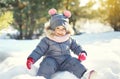 Happy smiling little child playing on snow in winter Royalty Free Stock Photo