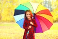 Happy smiling little girl child with colorful umbrella in sunny autumn Royalty Free Stock Photo