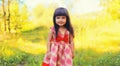 Happy smiling little girl child outdoors walking in sunny summer park Royalty Free Stock Photo