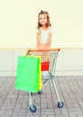 Happy smiling little girl child sitting in a trolley cart Royalty Free Stock Photo