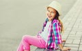 Happy smiling little girl child wearing a summer straw hat, pink plaid shirt Royalty Free Stock Photo