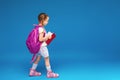 Happy smiling little girl with glasses goes to school for the first time Royalty Free Stock Photo