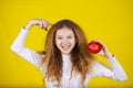 Happy, smiling little girl holding an red apple Royalty Free Stock Photo