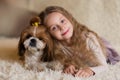 Happy smiling little girl hugging a dog Shih Tzu at home Royalty Free Stock Photo