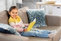 Happy smiling little girl reading book at home Royalty Free Stock Photo