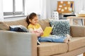 Happy smiling little girl reading book at home Royalty Free Stock Photo