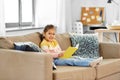 Happy smiling little girl reading book at home Royalty Free Stock Photo