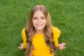 Happy smiling little girl relaxing green grass, carefree childhood concept Royalty Free Stock Photo