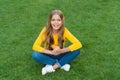 Happy smiling little girl relaxing green grass, excited child concept