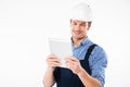 Happy smiling male builder using pc tablet