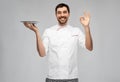 happy smiling male chef holding empty plate Royalty Free Stock Photo