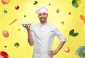 happy smiling male chef holding empty plate Royalty Free Stock Photo