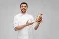 happy smiling male chef with pasta in glass jar Royalty Free Stock Photo