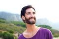 Happy smiling man with beard standing in outdoors in nature