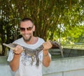 Happy smiling man holding a crocodile Royalty Free Stock Photo