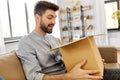 happy smiling man with open parcel box at home Royalty Free Stock Photo