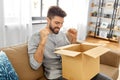happy smiling man with open parcel box at home Royalty Free Stock Photo