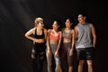 Happy smiling man and women having fun talking in gym. Group of young people relaxing in gym after workout training. Royalty Free Stock Photo