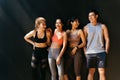Happy smiling man and women having fun talking in gym. Group of young people relaxing in gym after workout training. Royalty Free Stock Photo