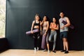 Happy smiling man and women having fun talking in gym. Group of young people relaxing in gym after workout training. Royalty Free Stock Photo