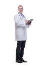 Happy smiling mature doctor with stethoscope around the neck writing on clipboard in a modern hospital Royalty Free Stock Photo