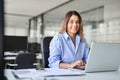 Happy mature professional business woman with laptop in office, portrait. Royalty Free Stock Photo