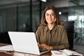 Happy mature professional business woman with laptop in office, portrait. Royalty Free Stock Photo