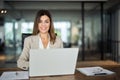 Happy mature professional business woman working on laptop in office, portrait. Royalty Free Stock Photo