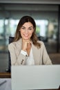 Happy mature professional business woman working on laptop in office, portrait. Royalty Free Stock Photo