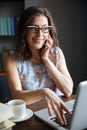 Happy smiling mature woman in eyeglasses talking on the phone Royalty Free Stock Photo