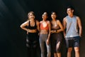 Happy smiling man and women having fun talking in gym. Group of young people relaxing in gym after workout training. Royalty Free Stock Photo