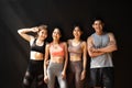 Happy smiling man and women having fun talking in gym. Group of young people relaxing in gym after workout training. Royalty Free Stock Photo