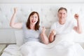 Happy smiling middle age couple in bed in t shirt. Healthy family relationships. Copy space