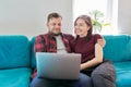 Happy smiling middle aged family couple looking at laptop screen together Royalty Free Stock Photo