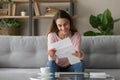 Happy smiling millennial girl holding paper document.