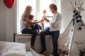 Family playing and spending time near window. Sunny day outside Royalty Free Stock Photo