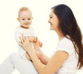 Happy smiling mother and baby having fun together on a white Royalty Free Stock Photo