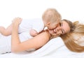 Happy smiling mother and baby playing on bed Royalty Free Stock Photo