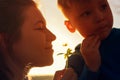 Happy smiling mother and child smelling flower Royalty Free Stock Photo